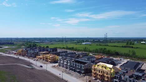 new home construction with builders working in community housing development near lake and farms