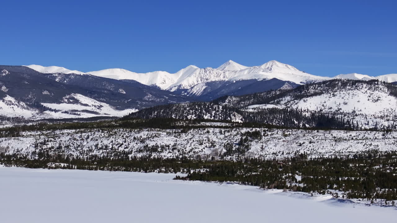 Snowy winter bluebird bluesky cold Colorado aerial drone frozen Lake Dillon Frisco Silverthorne Keystone Breckenridge landscape view Grays and Torreys fourteener i70 circle left slowly motion
