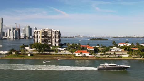 a panning drone shot of a yacht cruising through the intercostal