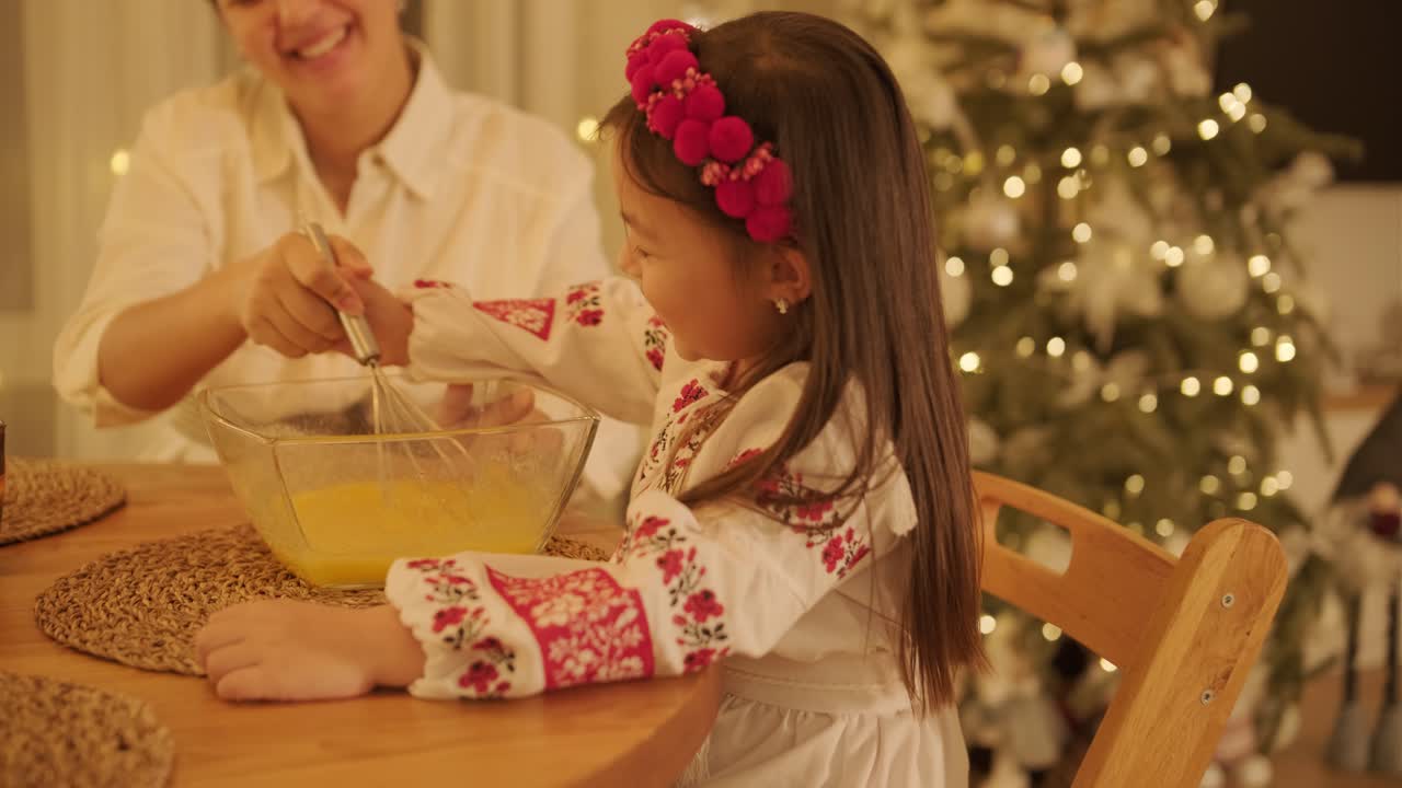 Mother and Daughter Preparing for Christmas Celebration