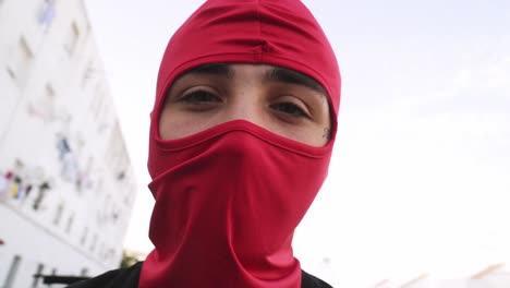 young man in red balaclava