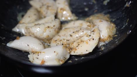 Delicious-fried-pelmeni-in-hot-steaming-pan-with-beautiful-herbs-sauce-on-it