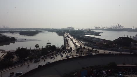 aerial view of native jetty road and jinnah flyover with karachi port terminal in background during sunset