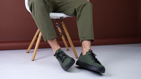 man wearing olive green sneakers