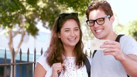 hipster smiling friends taking selfie with smartphone