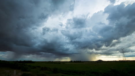 stormy weather time lapse, clouds moving overhead and shafts of rain falling during south east asia monsoon season.