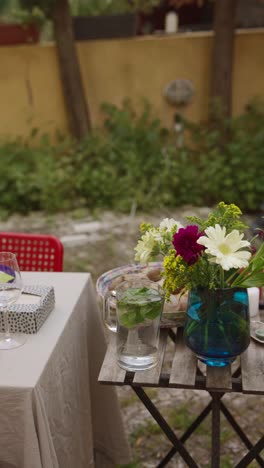 outdoor patio dinner setting with flowers and candles