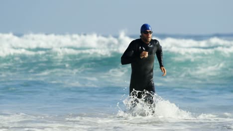 male surfer running in the beach