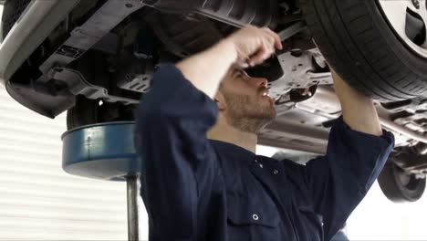 Handsome-mechanic-reparing-a-car