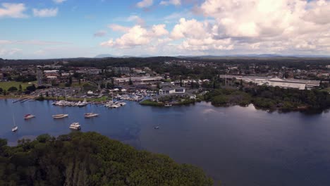 Aerial drone shot of La Gi coastal town with scenic marina, river, and surrounding infrastructure in Binh Thuan Province, Vietnam. Capturing natural beauty and development