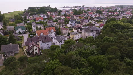 aerial tracking shot in front of houses in the jastarnia town, summer in poland