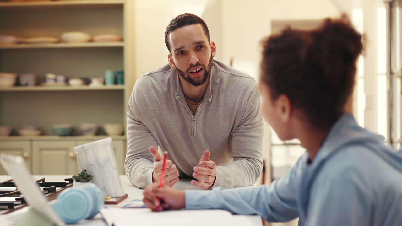 A father helping his daughter with her homework