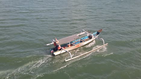 balinese jukung, canoe, cadik small boat sailing on water in bali indonesia