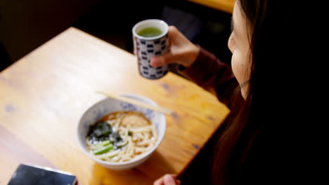 woman having tea in restaurant 4k