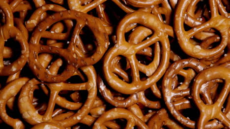 many salted pretzel snacks on a rotating surface