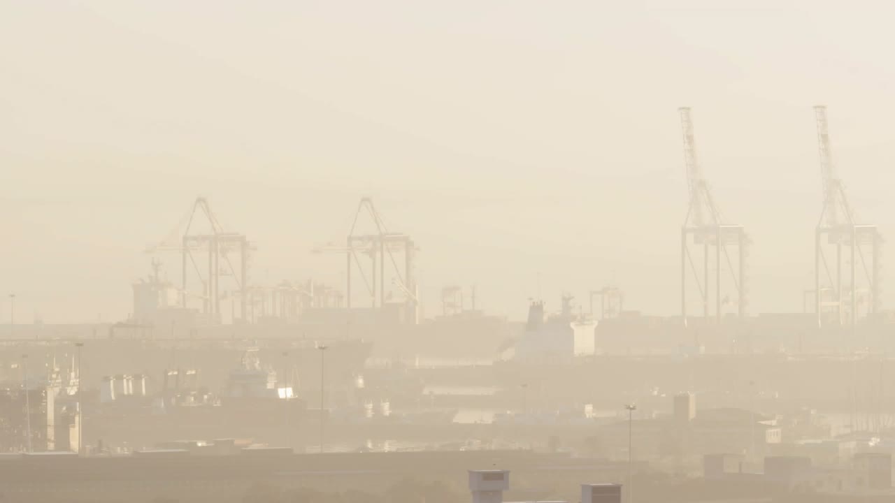 On data tick blue info cluster fading dropping scaling and settling over hazy port tracking cargo