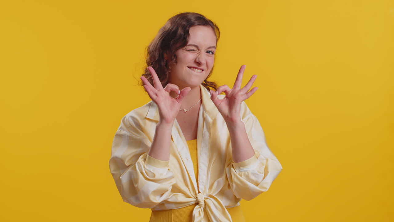 Woman looking approvingly showing ok approve feedback gesture like sign positive something good