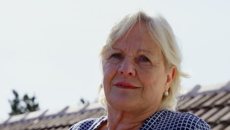 Senior-woman-standing-on-terrace-4k