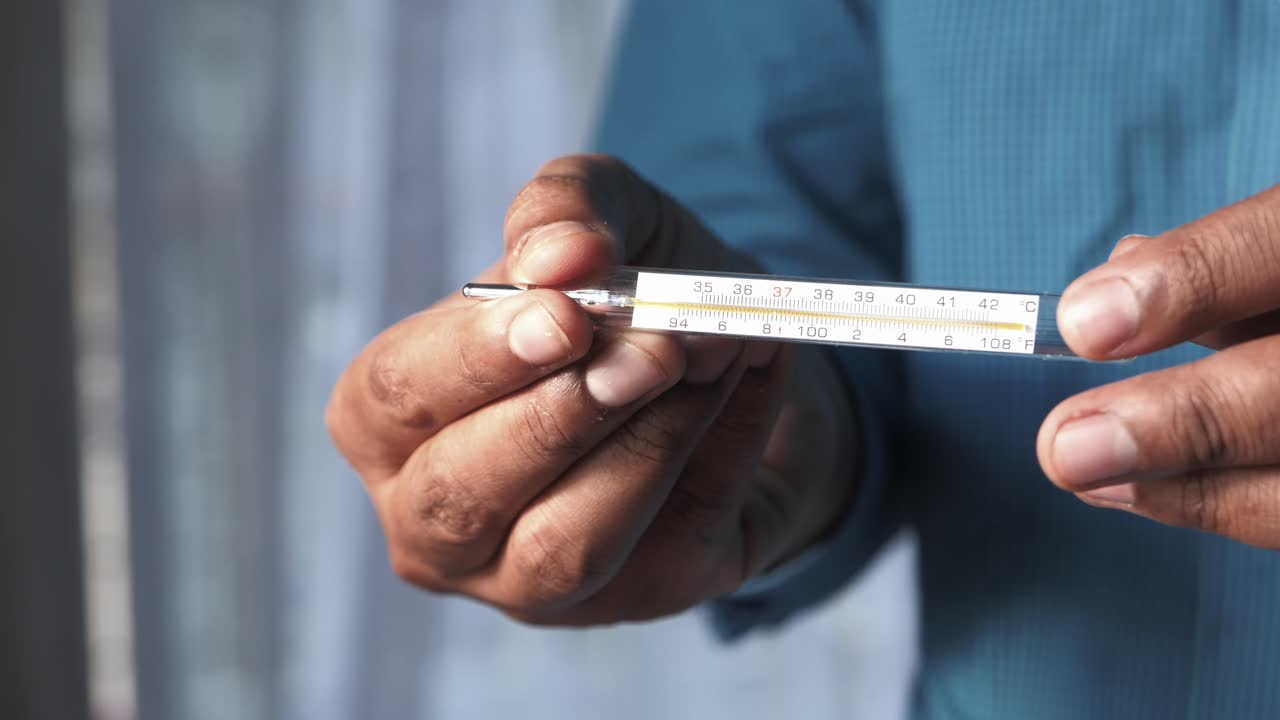 Person holding a thermometer