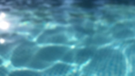 ripples on the surface of the transparent blue water in a pool