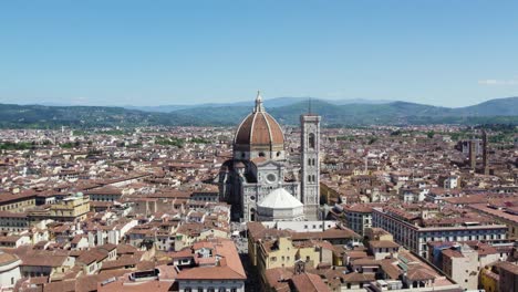 rising aerial above beautiful cathedral in town square of florence, italy