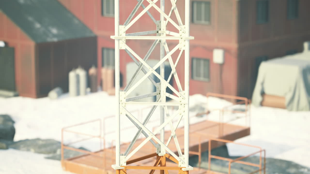 Construction tower at a snowy industrial site in winter sunlight