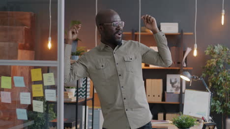 happy businessman celebrating success in office
