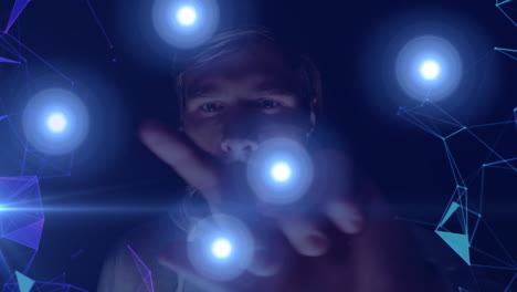 animation of network of connections with blue glowing spots over man using virtual screen