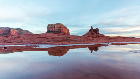 courthouse butte and bell rock reflections on puddle of water