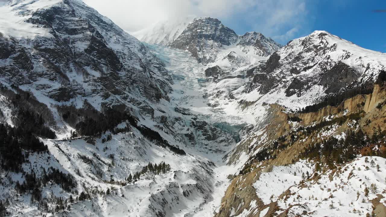 Aerial closing in shot of the huge glacier between Annapurna three and Gangapurna Himalaya Mountains in the Manang Valley, Nepal.
