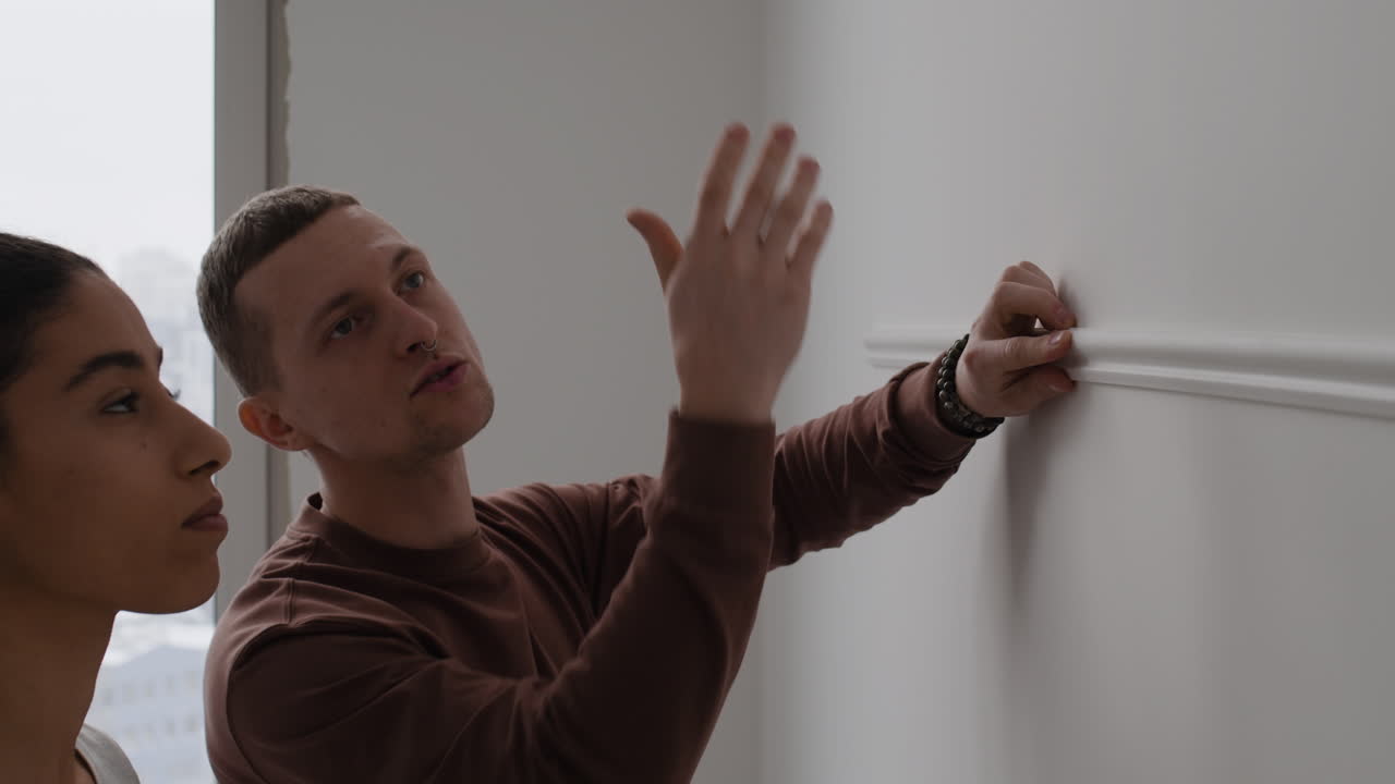 Couple Installing Wall Molding in Their New Apartment