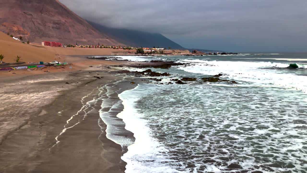 Huayquique beach Chile Iquique building ocean sea traffic tarapaca mountain birds foam
