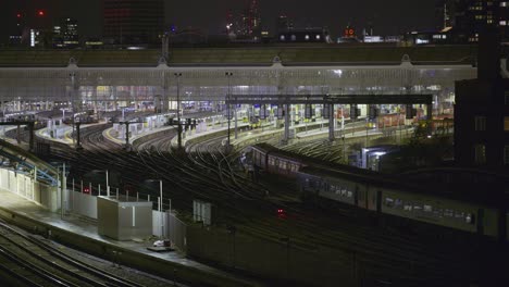 two trains arriving at london waterloo station at night simultaneously