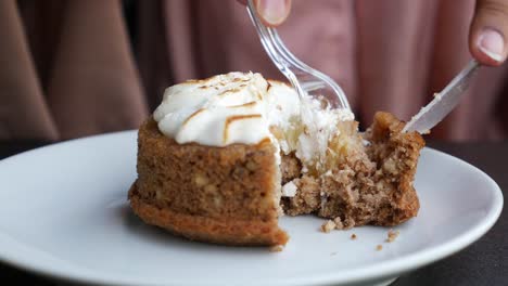 person eating a sliced apple cake with meringue topping