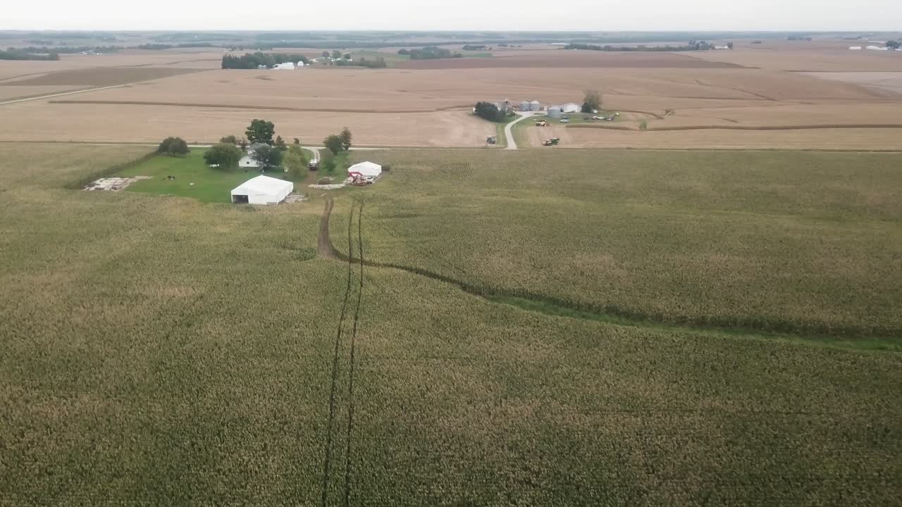 Aerial drone view in rural Iowa with a view of corn fields and farms with barns and silos