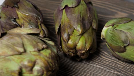 close-up of fresh artichokes on wooden background