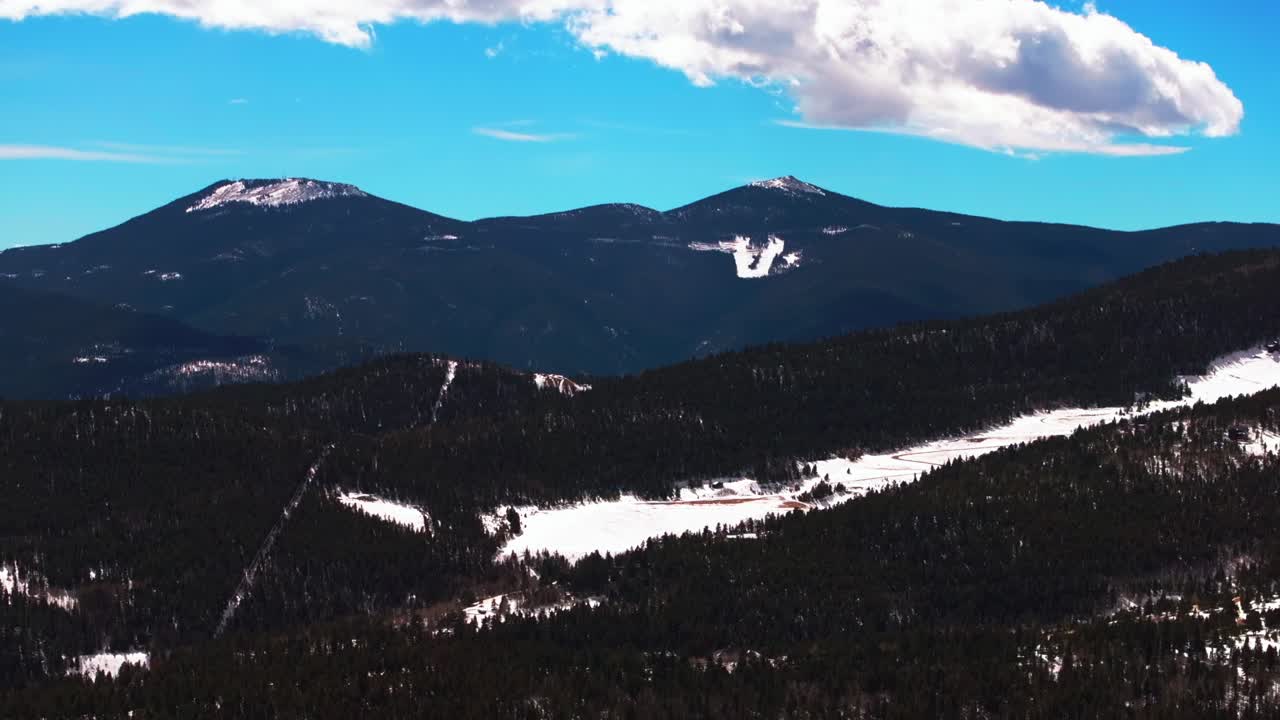 Idaho Springs Echo Mountain Chief mountain Mount Blue Sky wilderness Colorado aerial drone winter sunny blue sky clouds snow Central City Parkway daytime i70 Rocky Mountains circle left parllax