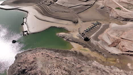 Drying-water-reservoir-of-quarry-in-Spain,-aerial-drone-view