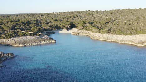 aerial drone panning around es talaier virgin beach in menorca, spain