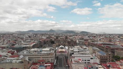 Aerial-panoramic-view-of-Mexico-City-downtown-plaza,-El-Zocalo,-with-views-of-the-Cathedral,-National-Palace