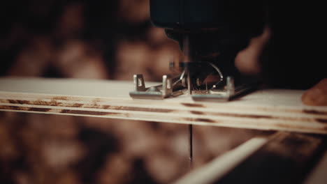 a slow motion of a carpenter cutting wood with a special machine