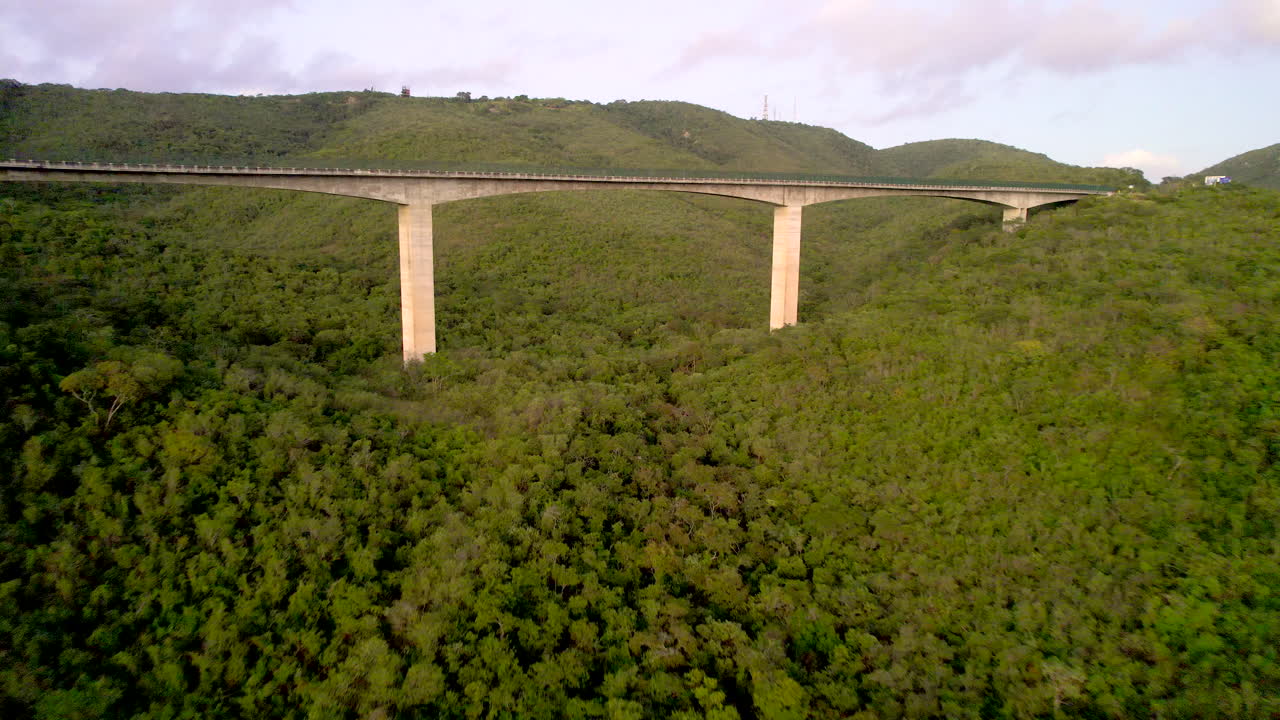 Aerial morning view of BR 232 highway and Cascavel bridge near Gravatá Pernambuco Northeast Brazil with blue sky lake and cars on the road.
