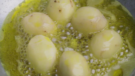 cooking potato with sizzling hot oil on a cooking pan