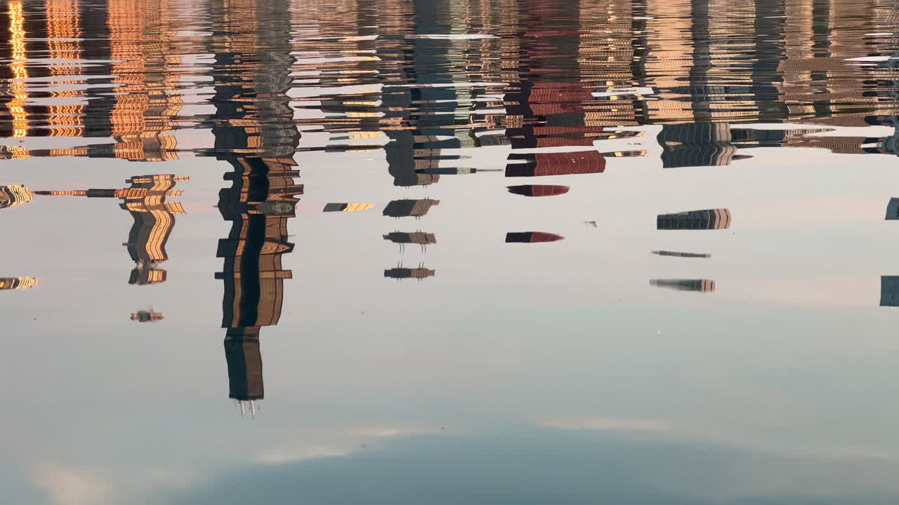 The Chicago skyline reflected on a wavy Lake Michigan just after sunrise in May