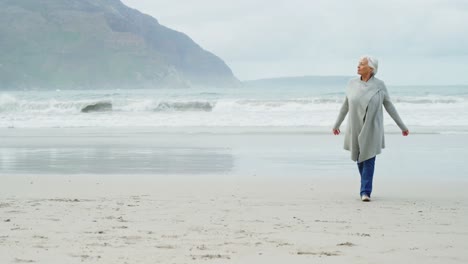 Senior-woman-walking-on-beach