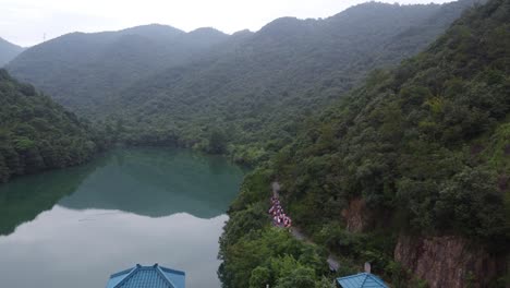 group hiking along a mountain lake path