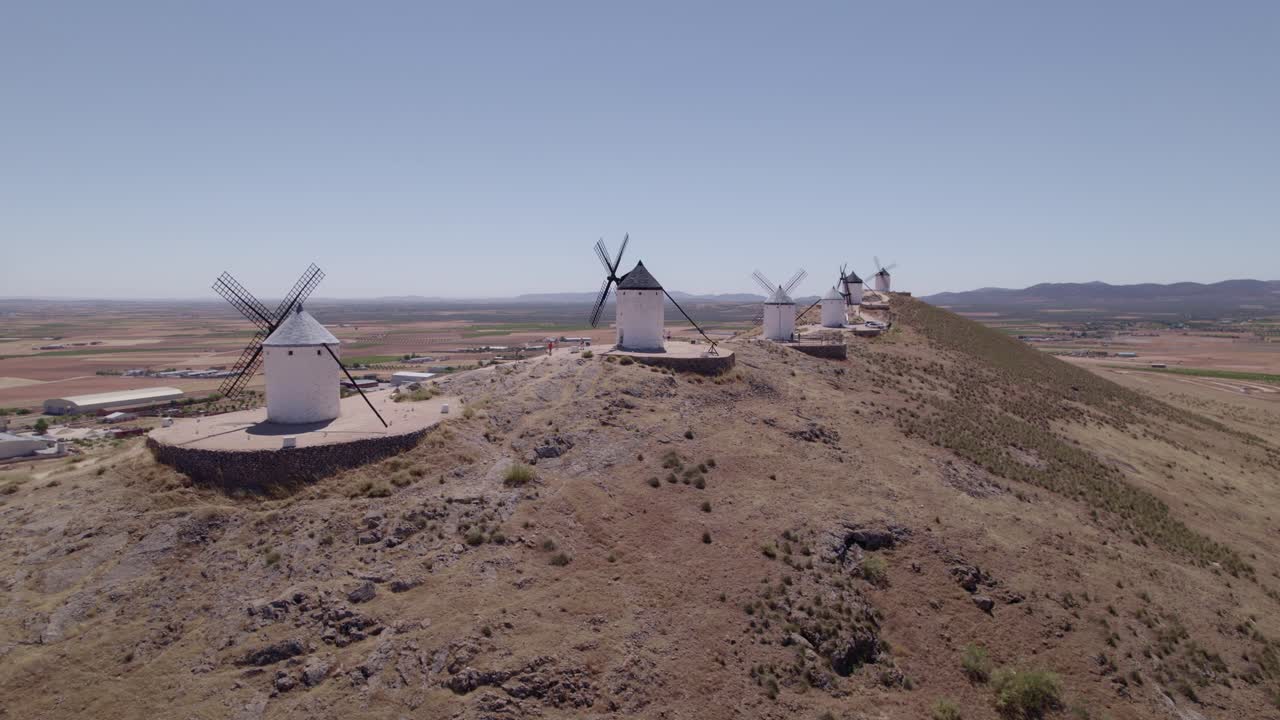 Don Quixote. La Mancha. Typical Spanish windmills. Panoramic aerial view of ancient windmills at midday. Aerial tracking shot. Consuegra Spain
