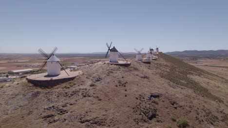 don quixote. la mancha. typical spanish windmills. panoramic aerial view of ancient windmills at midday. aerial tracking shot. consuegra spain