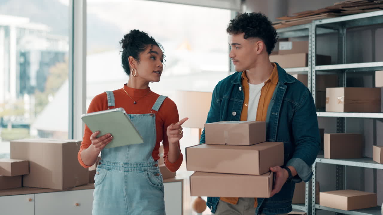 Entrepreneurs managing packages in warehouse