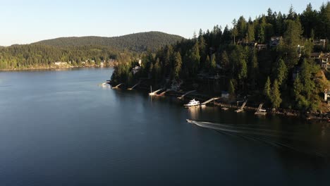 boat cruising during golden hour on the indian arm in british columbia